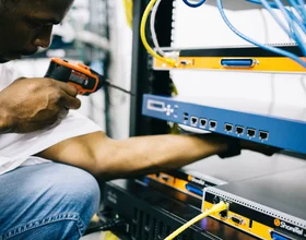 Black technician servicing hardware in a data centre