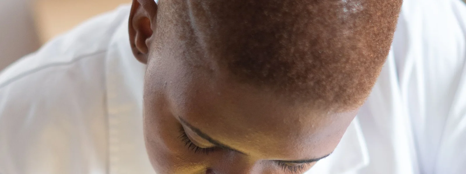 Black electronics technician testing a circuit board