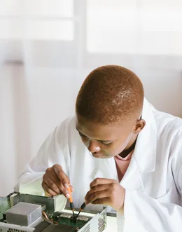 Black technician repairing computer hardware