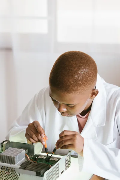 Black technician repairing computer hardware