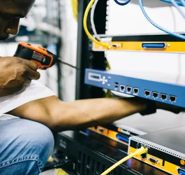 Black technician servicing hardware in a data centre