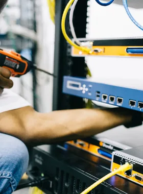 Black technician servicing hardware in a data centre