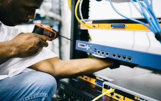 Black technician servicing hardware in a data centre