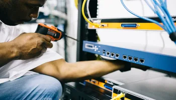 Black technician servicing hardware in a data centre