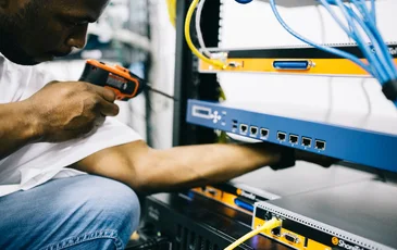 Black technician servicing hardware in a data centre