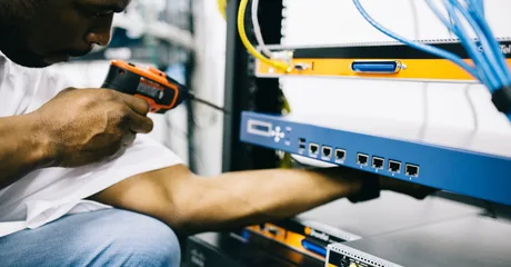 Black technician servicing hardware in a data centre