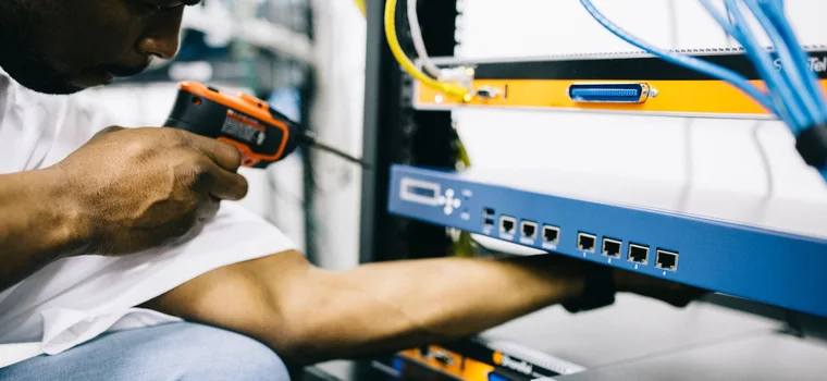 Black technician servicing hardware in a data centre