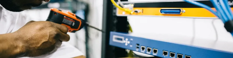 Black technician servicing hardware in a data centre
