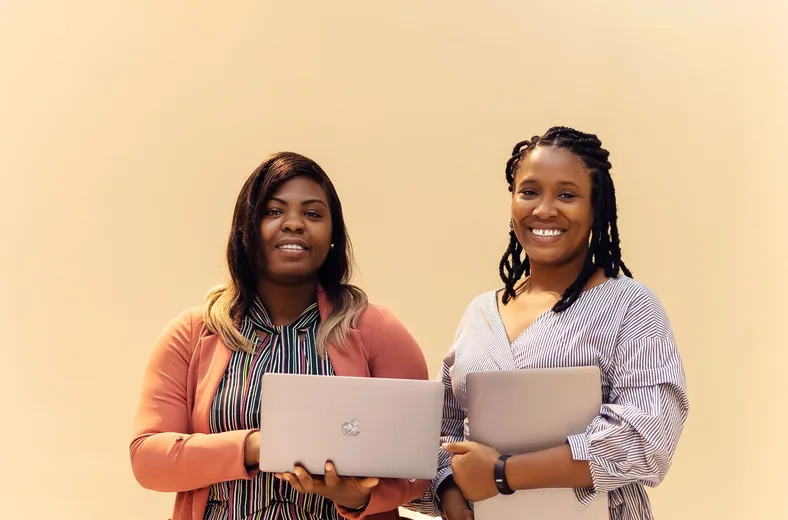 African businesswomen collaborating with laptops