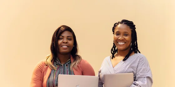 African businesswomen collaborating with laptops