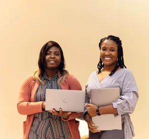 African businesswomen collaborating with laptops