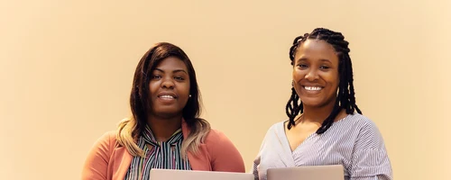 African businesswomen collaborating with laptops