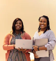 African businesswomen collaborating with laptops