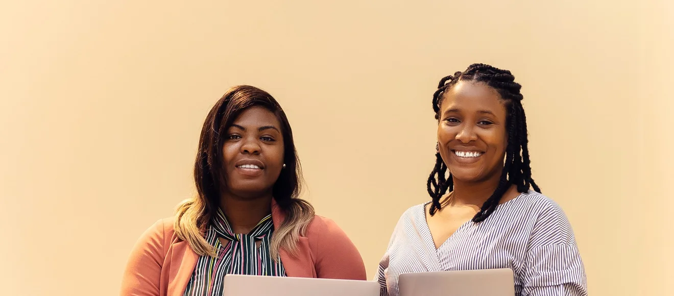 African businesswomen collaborating with laptops