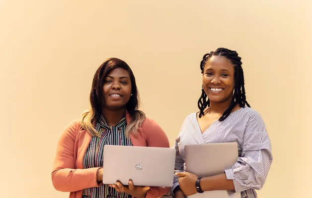 African businesswomen collaborating with laptops