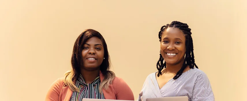 African businesswomen collaborating with laptops