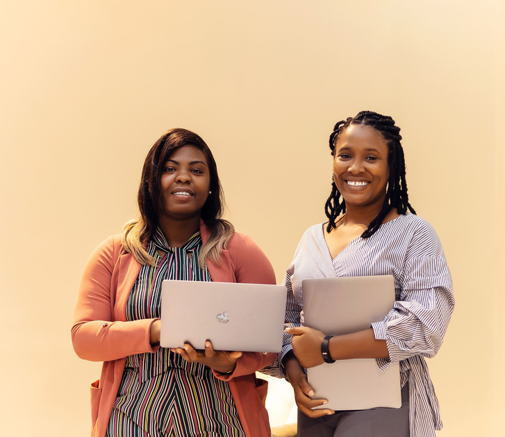 African businesswomen collaborating with laptops