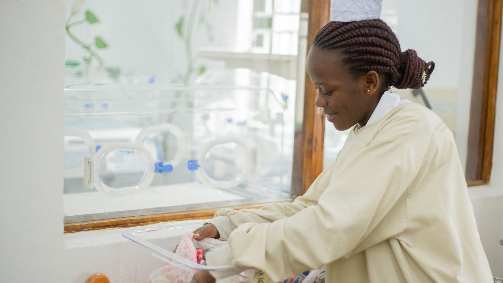 Nurse caring for a newborn in a hospital nursery