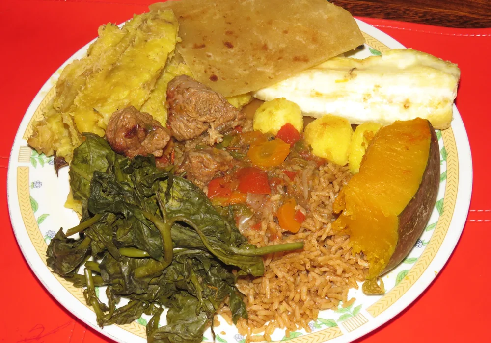 A Ugandan meal with matooke, pilau, cassava, chapati, vegetables and beef stew