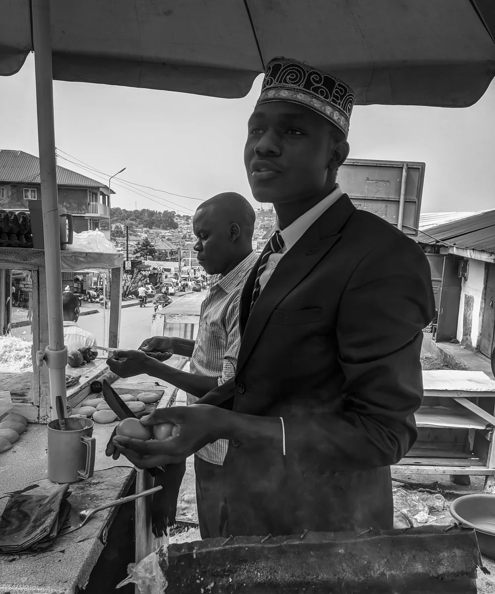 Street vendor preparing a Ugandan rolex in Kampala