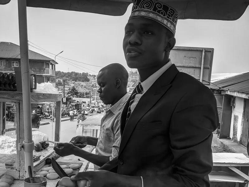 Street vendor preparing a Ugandan rolex in Kampala