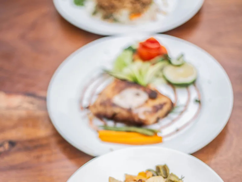 Three colourful plated dishes photographed in Uganda