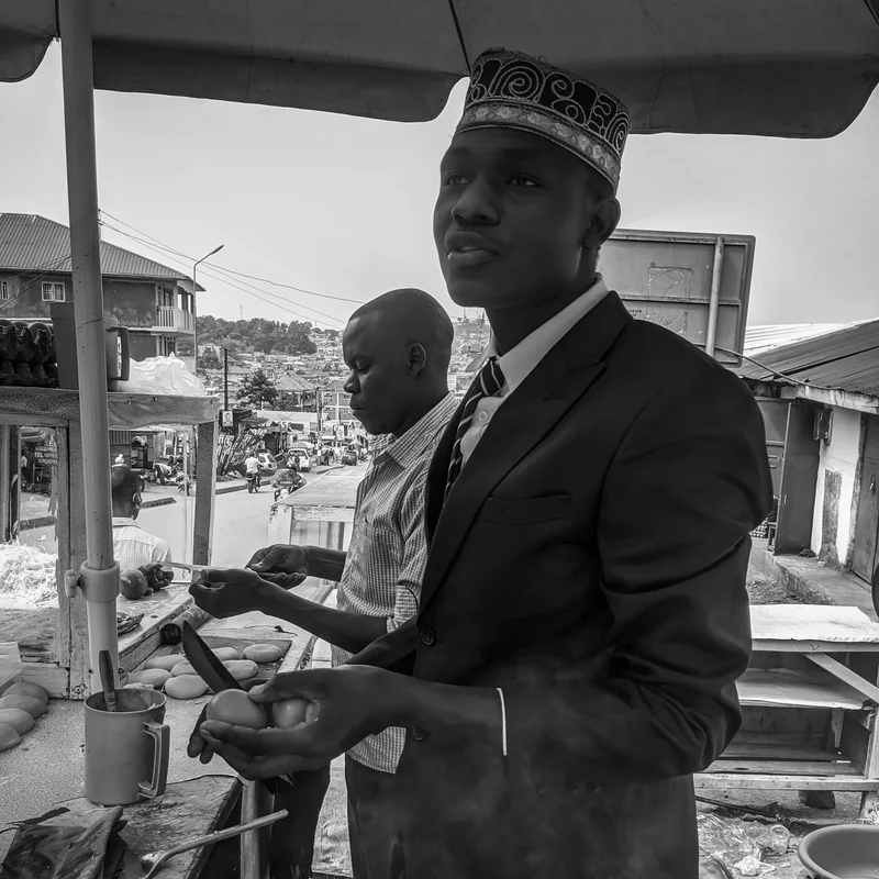 Street vendor preparing a Ugandan rolex in Kampala