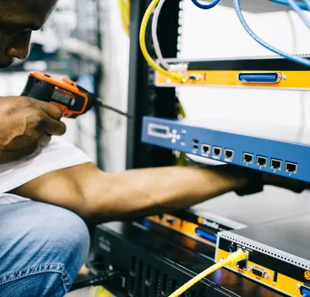 Black technician servicing hardware in a data centre