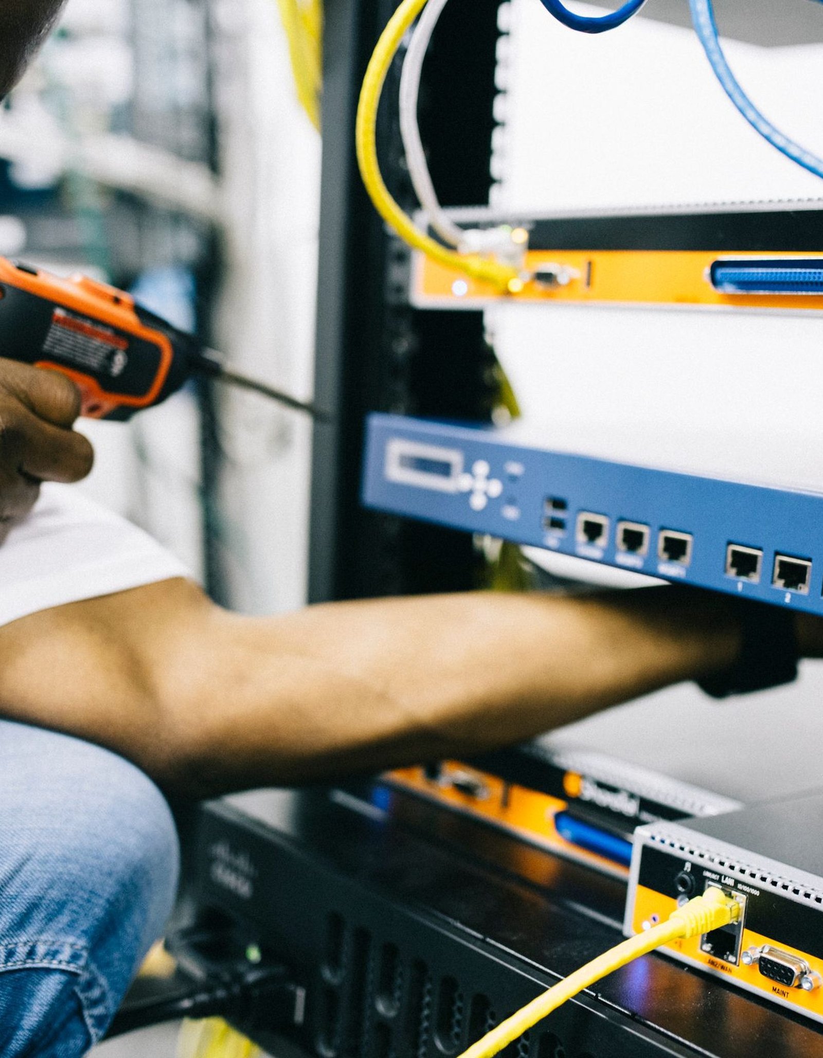 Black technician servicing hardware in a data centre