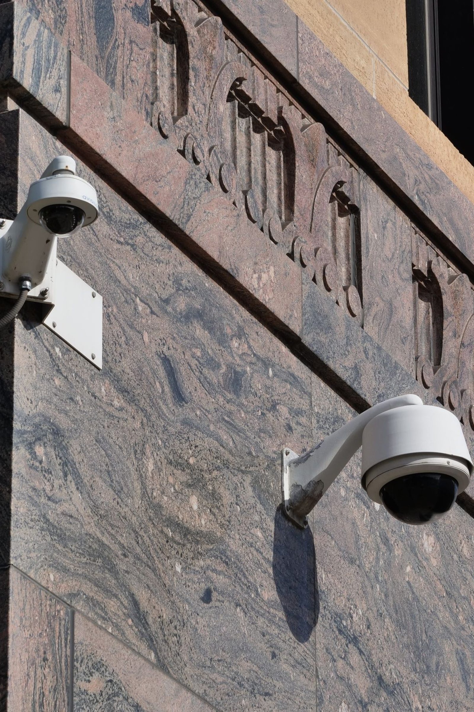 Modern surveillance cameras mounted on a building
