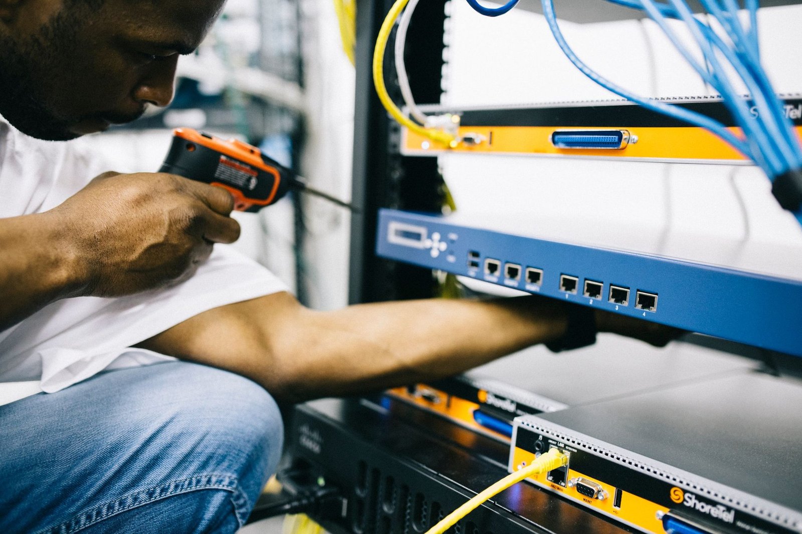 Black technician servicing hardware in a data centre