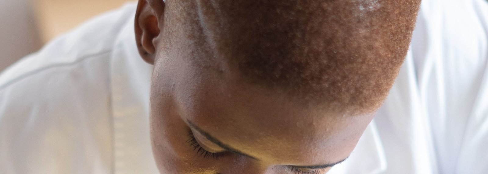 Black electronics technician testing a circuit board