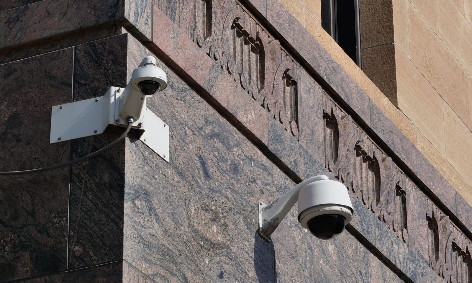 Modern surveillance cameras mounted on a building