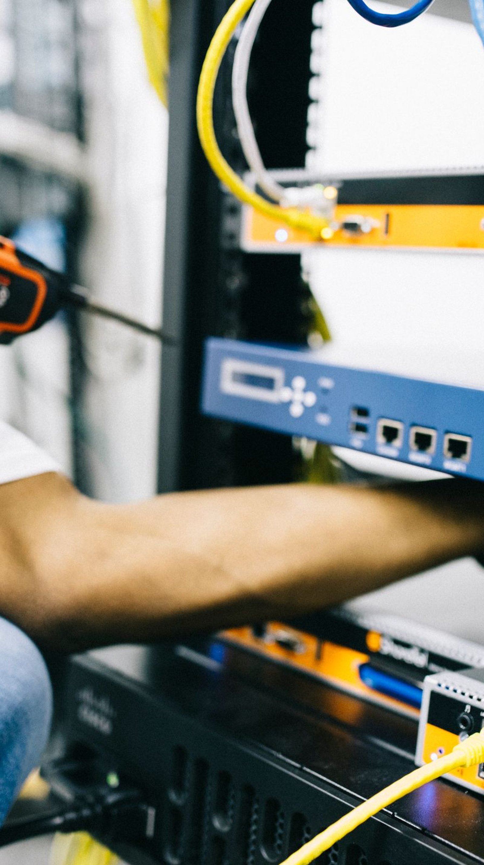 Black technician servicing hardware in a data centre