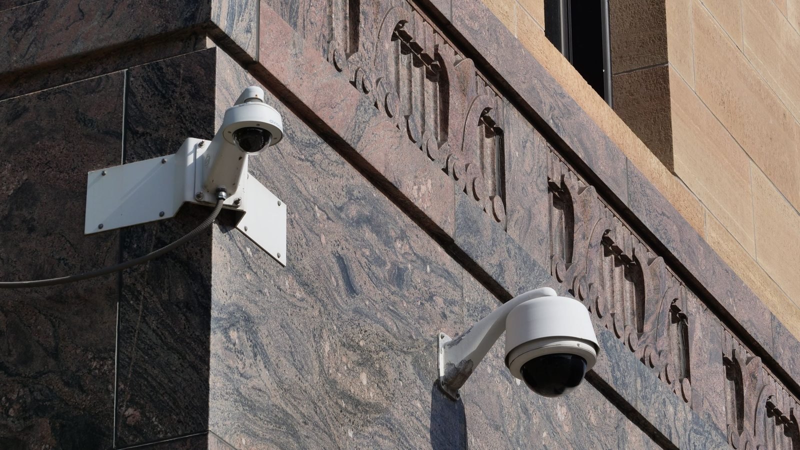 Modern surveillance cameras mounted on a building