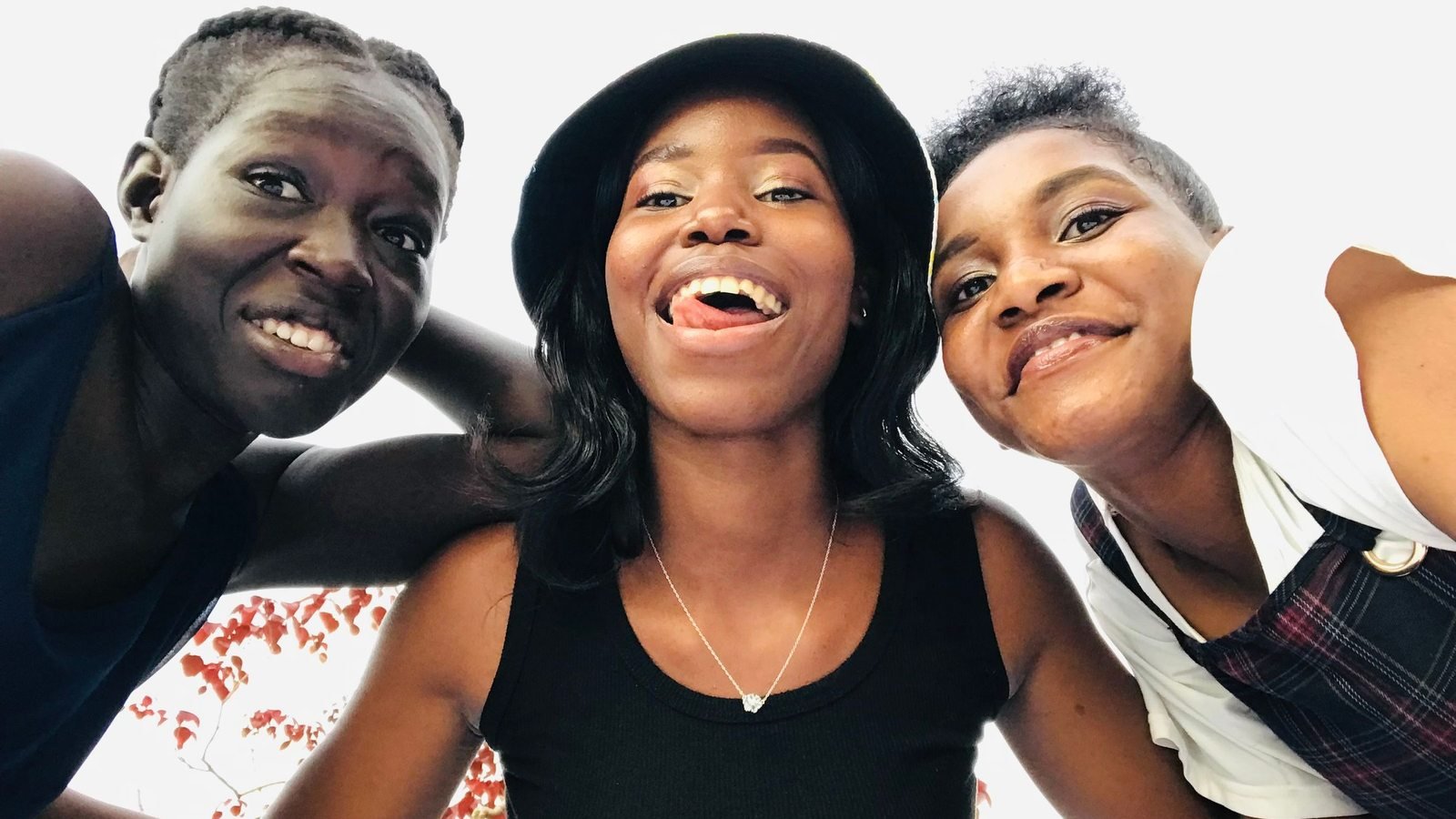 Three friends together outdoors in Kampala