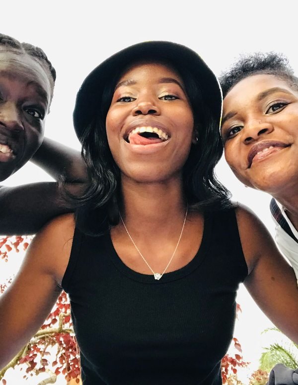 Three friends together outdoors in Kampala