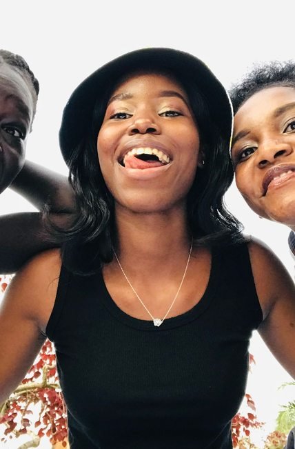 Three friends together outdoors in Kampala