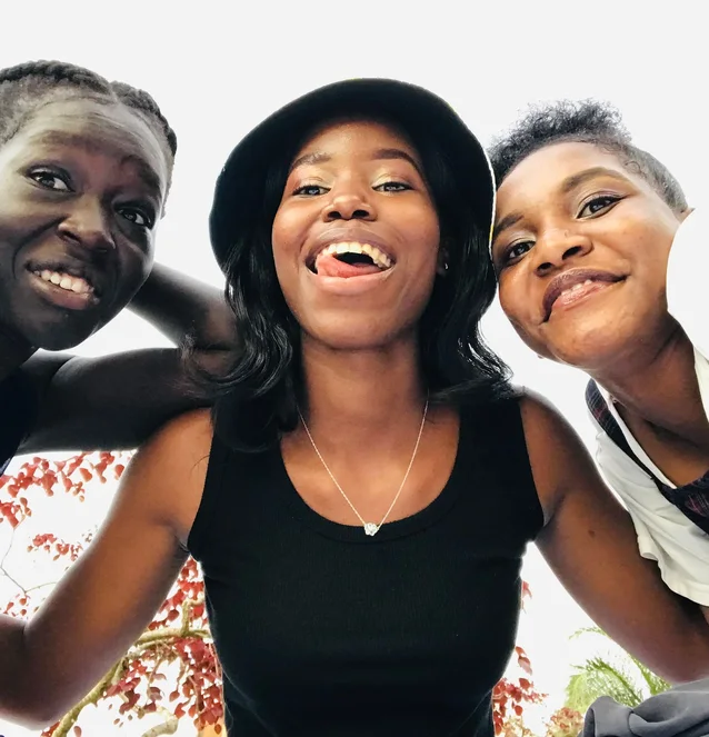 Three friends together outdoors in Kampala
