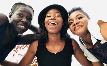 Three friends together outdoors in Kampala