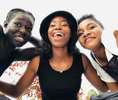 Three friends together outdoors in Kampala