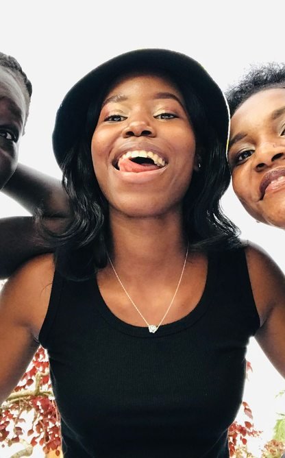 Three friends together outdoors in Kampala