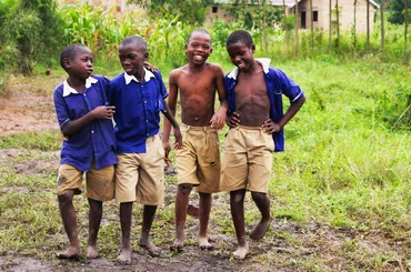 Schoolchildren in uniform smiling together in Uganda
