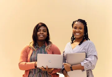 African businesswomen collaborating with laptops