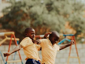 Children playing football in a Kampala schoolyard