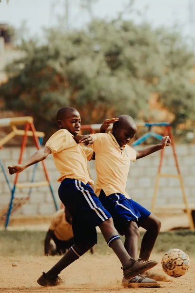 Children playing football in a Kampala schoolyard