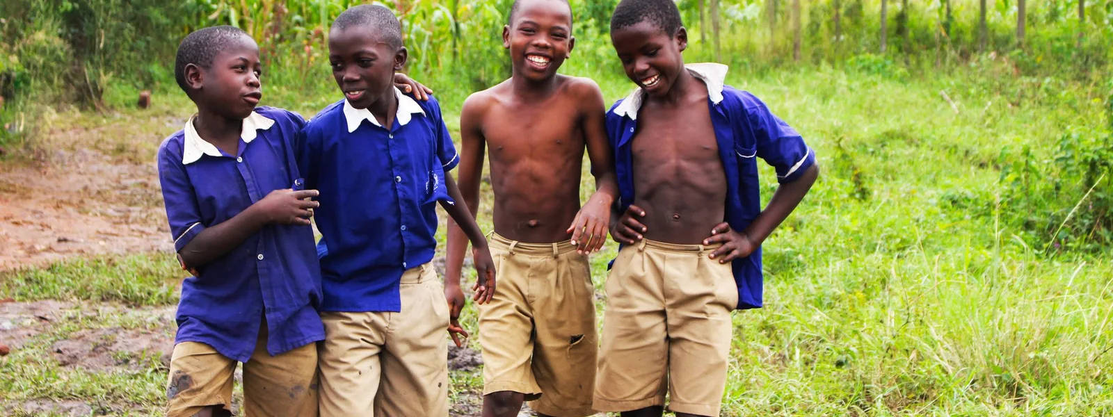 Schoolchildren in uniform smiling together in Uganda