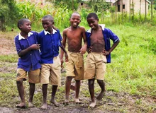Schoolchildren in uniform smiling together in Uganda