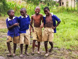 Schoolchildren in uniform smiling together in Uganda