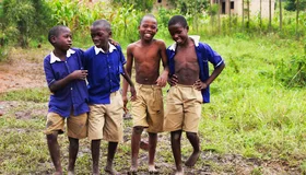 Schoolchildren in uniform smiling together in Uganda